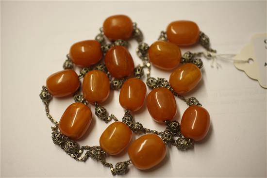 A single strand amber bead and filligree white metal necklace, 37in.